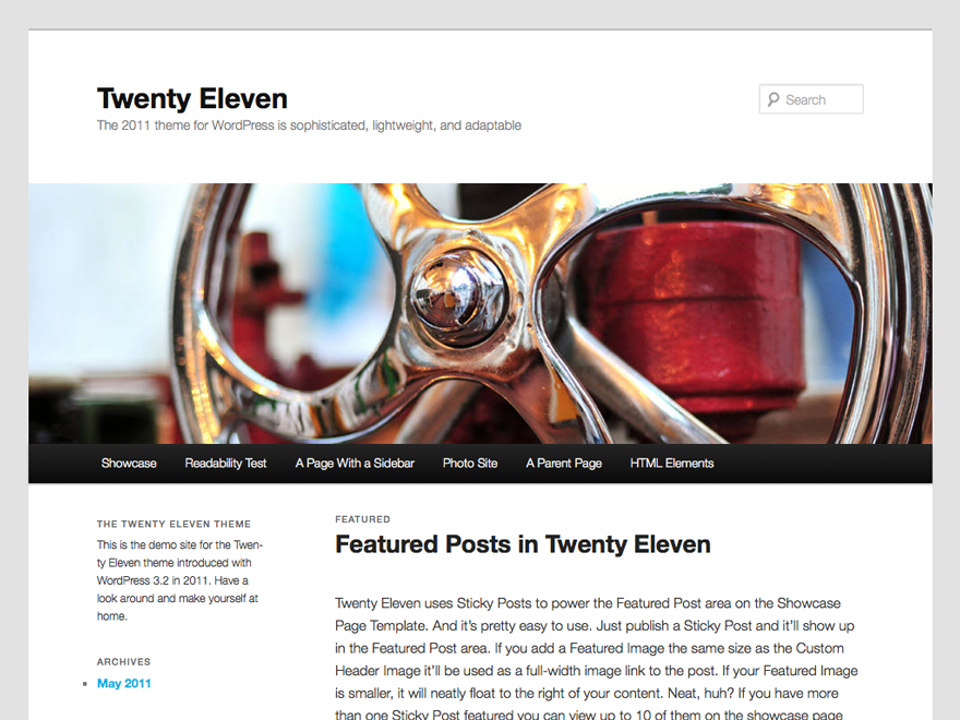Screenshot of Twenty Eleven.
The theme has a light grey body background, white content background, and dark grey text.
A full width image is displayed below the site title. Below the header image is a horizontal menu with black background and white text. The main section is split into two columns, with the content on the right and a narrow sidebar on the left.